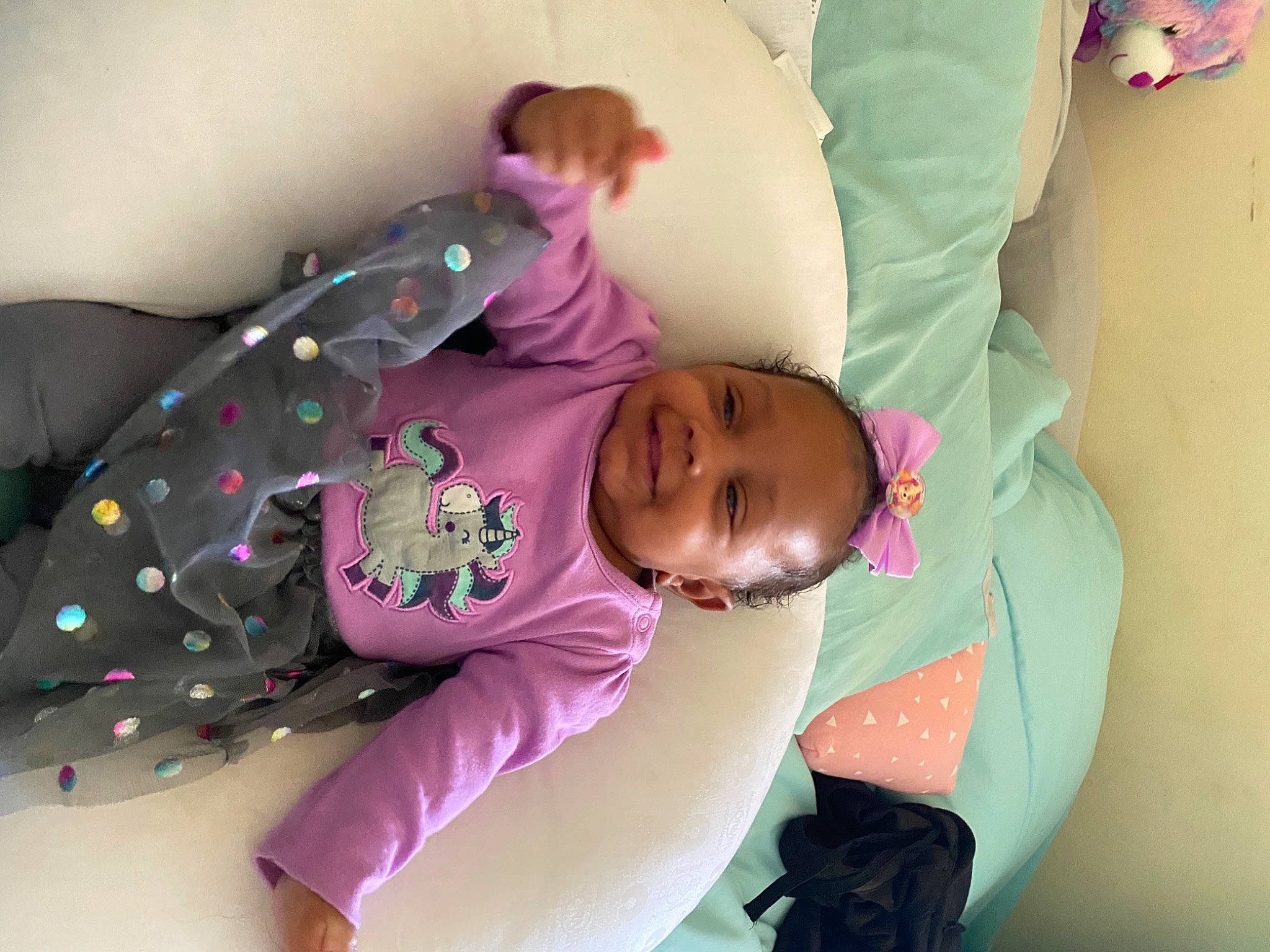 Kenleigh is registered to the contest to win money with this photo: baby, baby_products, baby_sleeping, baby_toddler_clothing, bedtime, child, comfort, happy, joy, linens, magenta, nap, pattern, person, pink, purple, room, sitting, skin, sleeve