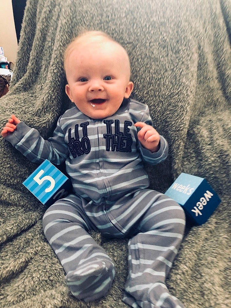 Logan joined the competition — help win amazing prizes! baby, baby_toddler_clothing, cheek, child, cool, electronic_device, face, facial_expression, head, people, person, play, product, sitting, skin, sleeve, smile, t_shirt, toddler