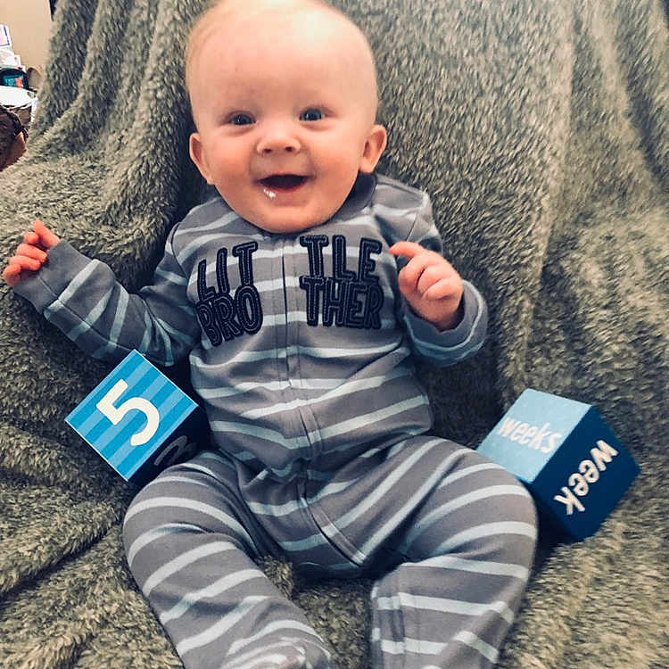 Logan joined the competition — help win amazing prizes! baby, baby_toddler_clothing, cheek, child, cool, electronic_device, face, facial_expression, head, people, person, play, product, sitting, skin, sleeve, smile, t_shirt, toddler