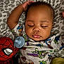 baby, sleeping, pacifier, toy_story, spiderman, plush_toy, onesie, blanket, bed, child, cute, infant, peaceful, soft, resting, comfort, pattern, hand, face, closeup