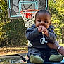 Nova is registered to the contest to win money with this photo: baby, basketball_hoop, car, child, clothing, cute, daylight, fall, greenery, hand, holding, nature, outdoor, pacifier, person, playing, roof, smiling, socks, trees