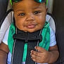 Nova joined the competition — help win amazing prizes! baby, child, car_seat, sunglasses, smile, face, hand, clothing, bib, seatbelt, infant, cute, portrait, person, green, black, white, cactus, safety, closeup
