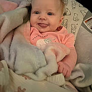 Adalynne joined the competition — help win amazing prizes! baby, bear, blanket, child, clothing, cozy, cute, expression, face, hand, indoors, infant, pattern, person, pink, portrait, seat, smile, soft, tongue