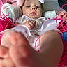 baby, infant, bow, feet, blanket, pink, white, clothing, tutu, face, hand, soft_toy, decor, closeup, portrait, child, cute, laying_down, indoor, playful