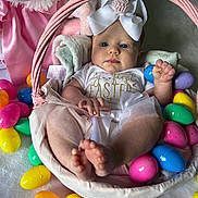 Adalynne joined the competition — help win amazing prizes! baby, basket, easter, easter_eggs, plastic_eggs, plush_toy, pink, white, headband, cute, child, holiday, celebration, infant, portrait, indoor, soft_toy, festive, clothing, smiling