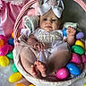 baby, basket, easter, easter_eggs, plastic_eggs, plush_toy, pink, white, headband, cute, child, holiday, celebration, infant, portrait, indoor, soft_toy, festive, clothing, smiling