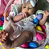 baby, infant, basket, easter_eggs, colorful, pink, white_bow, tutu, cute, foot, hand, clothing, indoors, celebration, holiday, soft_fabric, playful, portrait, child, person