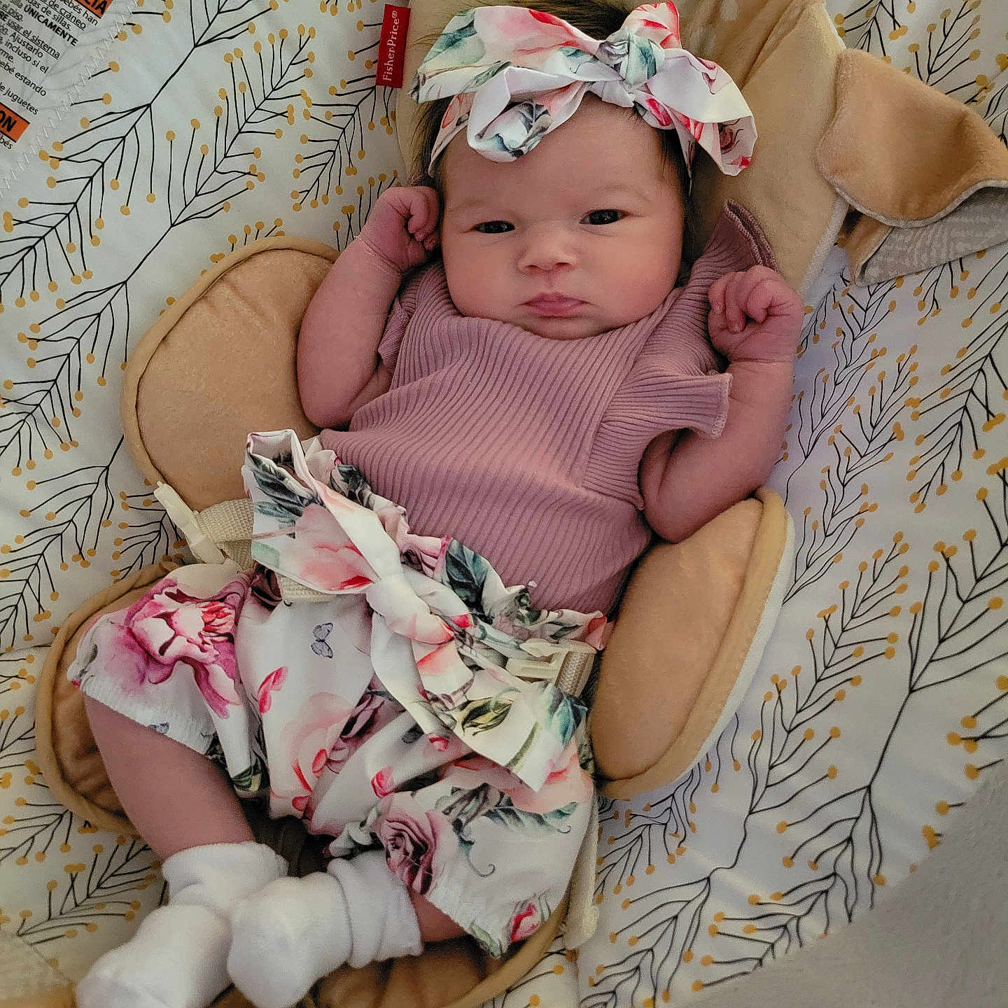 Lily joined the competition — help win amazing prizes! baby, infant, child, headband, floral, pattern, cushion, seat, clothing, socks, cute, portrait, indoors, comfortable, soft, newborn, face, hands, lying, resting