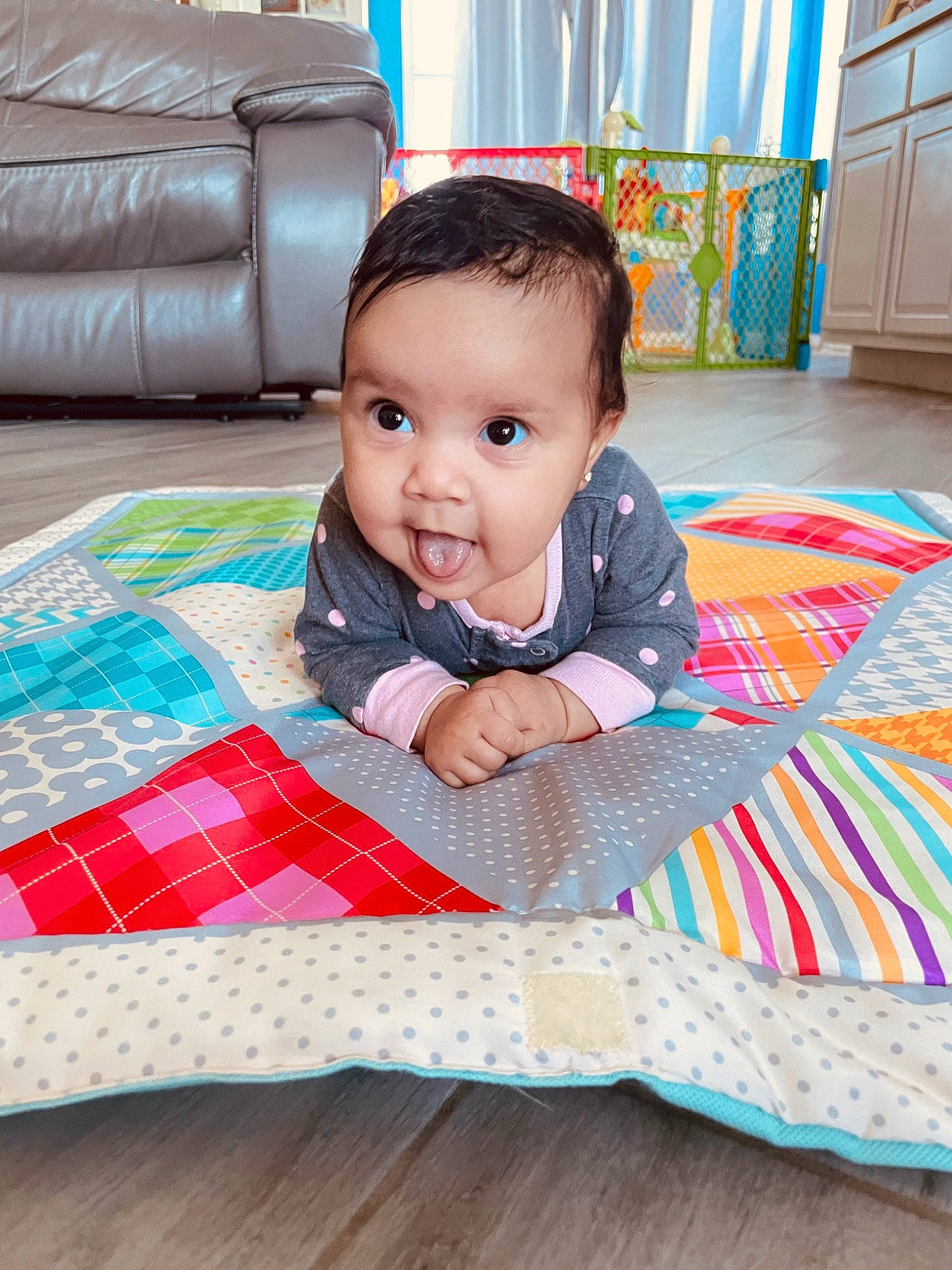 Elliana is registered to the contest to win money with this photo: baby, baby_toddler_clothing, blue, cabinetry, child, comfort, couch, eye, floor, flooring, hardwood, pattern, person, pink, plaid, product, skin, tartan, textile, toddler