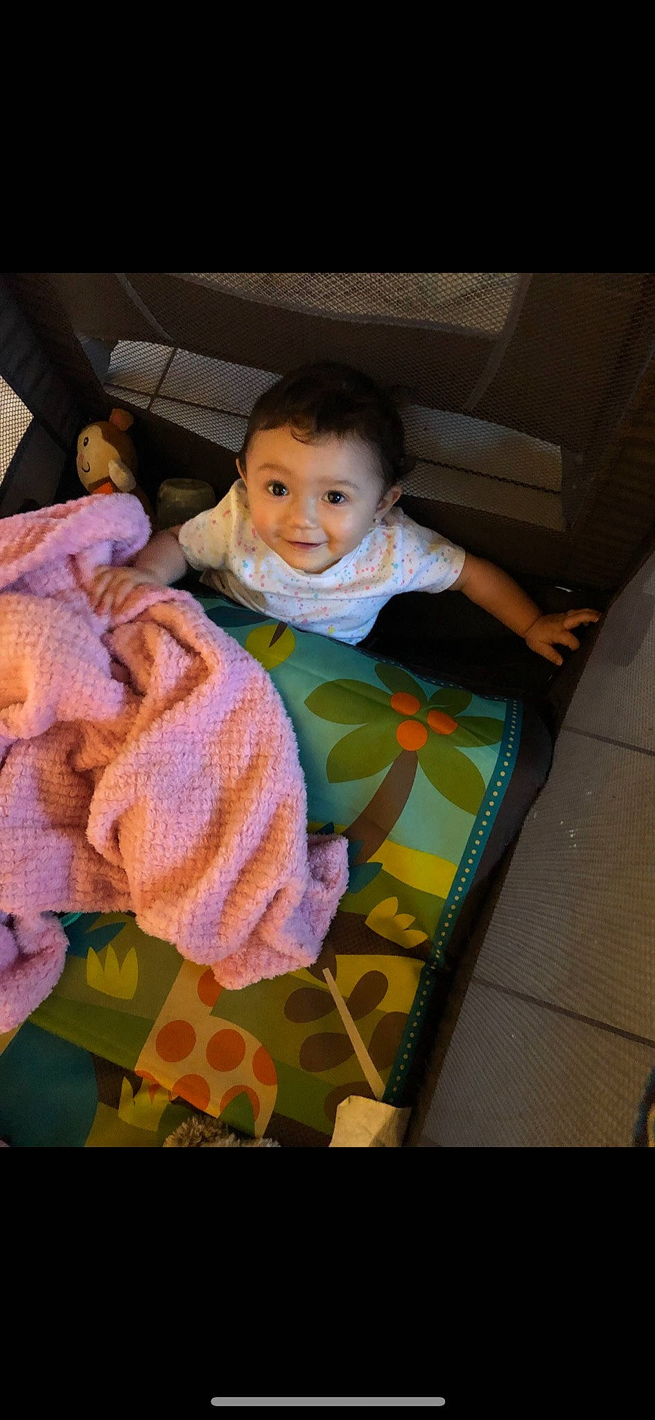Amalia is registered to the contest to win money with this photo: baby, baby_carriage, baby_products, baby_toddler_clothing, car_seat, cheek, child, comfort, flooring, joy, linens, mammal, pattern, person, pink, purple, room, sitting, smile, t_shirt