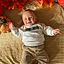 Maël a rejoint le concours — aidez-le/la à gagner de superbes lots ! baby, child, smiling, autumn_leaves, plush_toy, pumpkin, blanket, corduroy_pants, sweater, blue_eyes, happy, indoor, lying_down, cozy, seasonal, fall, cute, infant, footwear, soft_texture