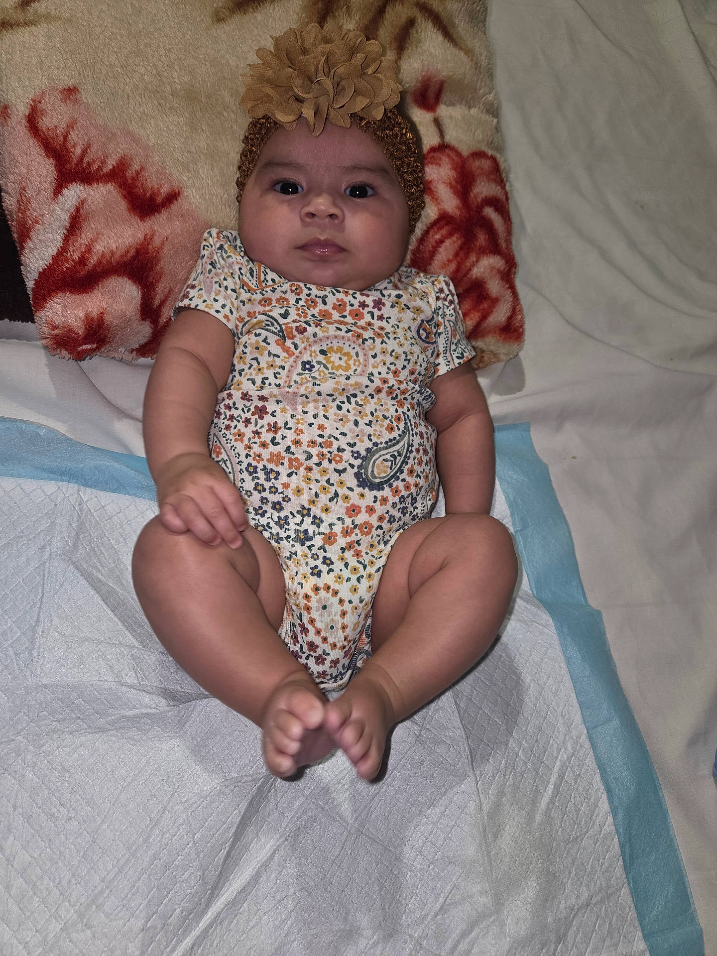 Abryana joined the competition — help win amazing prizes! baby, blanket, child, comfort, cute, expression, face, flower, foot, hand, headband, indoors, infant, lying_down, onesie, person, portrait, resting, skin, soft_texture