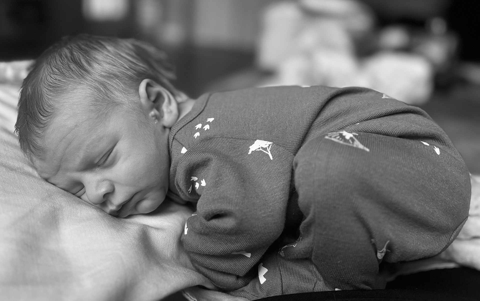 Shane joined the competition — help win amazing prizes! baby, sleeping, pajamas, black_and_white, infant, closeup, soft, peaceful, face, hair, fabric, portrait, child, cozy, rest, newborn, cute, indoors, person, blanket