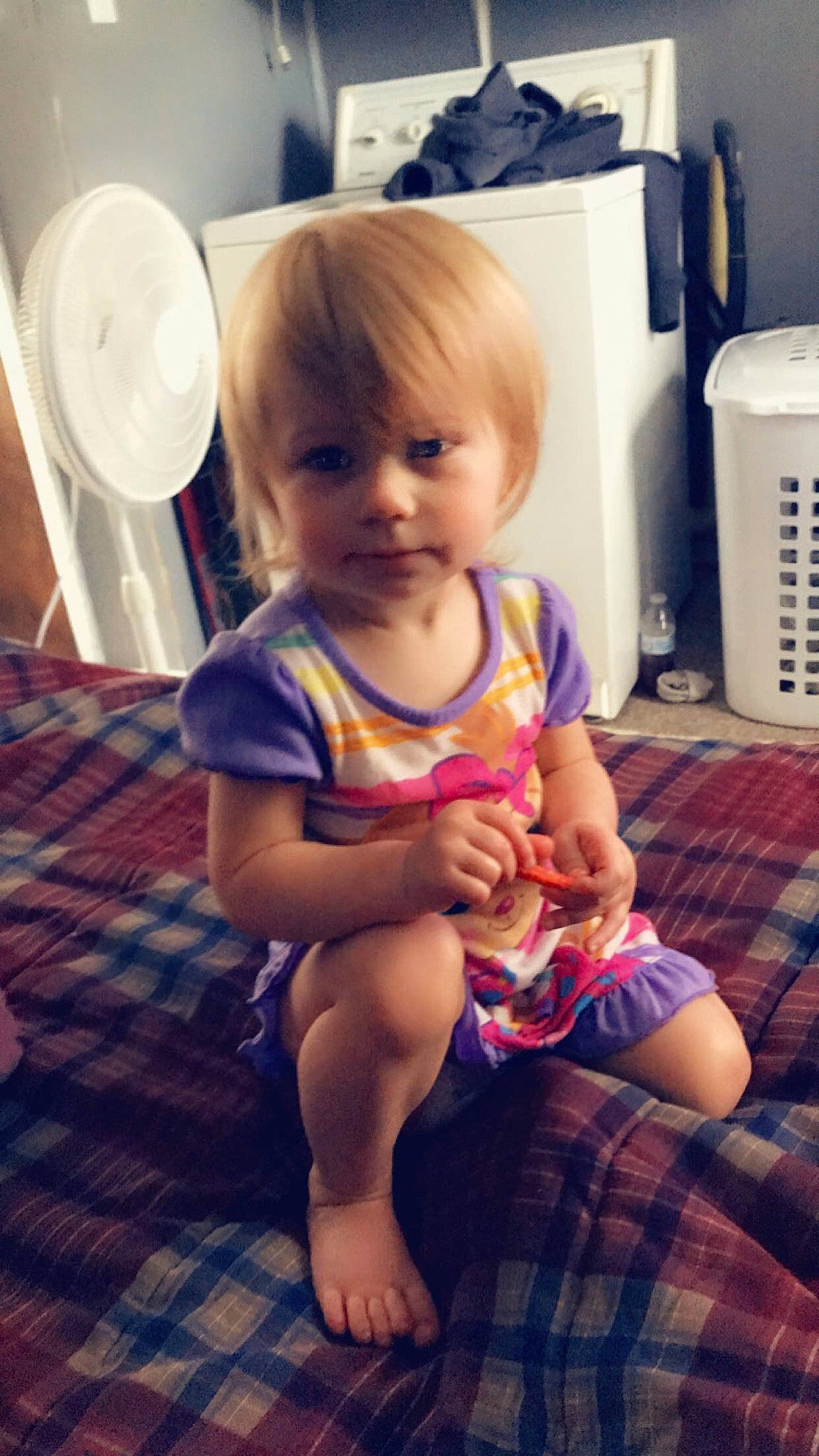 Addilyn is registered to the contest to win money with this photo: baby, beauty, cheek, child, electronic_device, eye, face, happy, head, leg, person, plaid, play, sitting, skin, smile, toddler