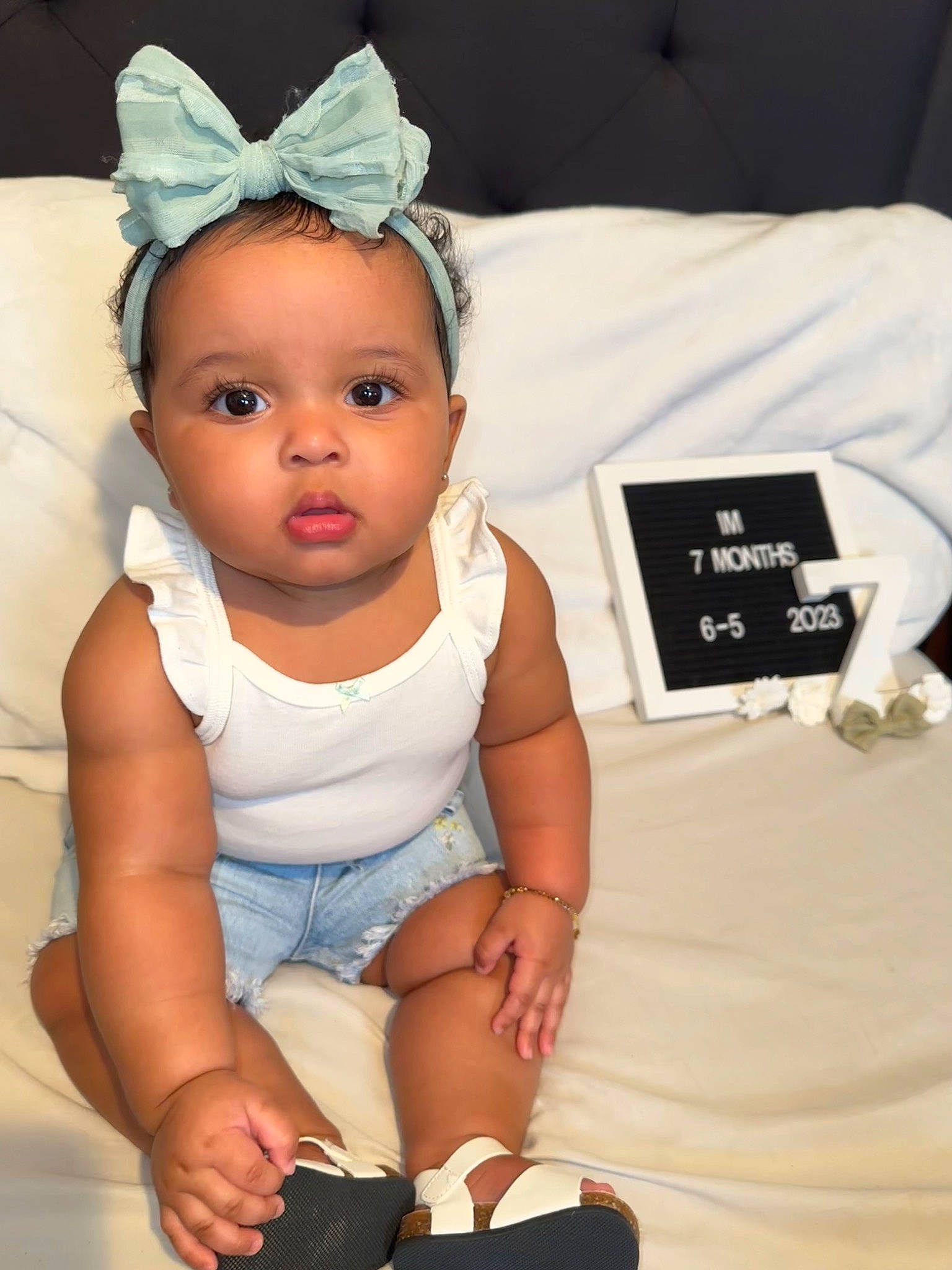 Zuri joined the competition — help win amazing prizes! baby, baby_toddler_clothing, child, comfort, cool, costume_hat, eyelash, fashion_accessory, finger, flash_photography, happy, headband, headpiece, jewellery, person, product, skin, sleeve, thumb, toddler