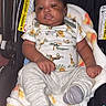 Nykie is registered to the contest to win money with this photo: baby, baby_garment, blanket, car_seat, child, clothing, comfort, cute, face, indoor, infant, newborn, onesie, person, protection, resting, seat, socks, soft_texture, warning_label