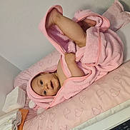 Irina participe au concours pour gagner de l'argent avec cette photo : baby, infant, towel, pink, blanket, face, smile, lying_down, changing_pad, heart_pattern, cute, child, skin, arm, leg, indoors, soft_texture, happy, playful, newborn