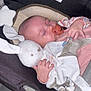 baby, sleeping, car_seat, pacifier, plush_toy, bunny, child, infant, seatbelt, safety, warning_label, clothing, hand, head, indoor, transportation, resting, cute, peaceful, soft_toy
