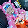 airbag, baby, blanket, blue_bow, car_interior, car_seat, child, cute, eyes, face, hand, hat, hooded_jacket, infant, pacifier, pink_clothing, polka_dots, seatbelt, warm_clothing, warning_sign