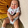 Lilyana participe au concours pour gagner de l'argent avec cette photo : baby, smiling, infant, onesie, white_clothing, plush_pillow, orange_pillow, lion_pillow, blanket, sitting, happy, cute, child, indoors, cozy, clapping_hands, sock, toddler, portrait, soft_furniture