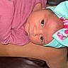 Sol is registered to the contest to win money with this photo: baby, infant, headband, pink_clothing, person, legs, leather_couch, skin, face, eyes, newborn, child, indoors, resting, cute, adorable, portrait, closeup, human, comfort