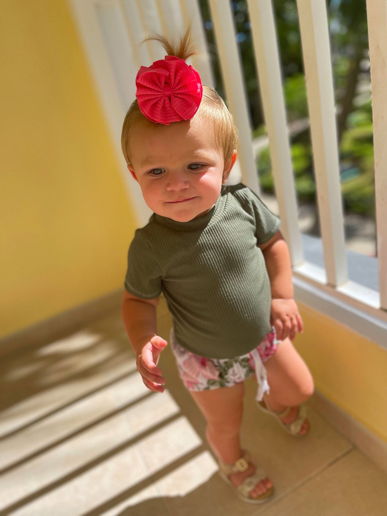 Mckenna is registered to the contest to win money with this photo: baby, baby_products, baby_toddler_clothing, child, flooring, foot, happy, hardwood, hat, headband, human_leg, joy, leg, pattern, person, pink, sandal, skin, sleeve, smile