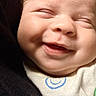 baby, smiling, close_up, face, infant, happy, eyes_closed, cute, skin, clothing, fabric, portrait, newborn, child, soft, cozy, expression, cheeks, small, peaceful