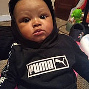 Pierre joined the competition — help win amazing prizes! baby, background, carpet, casual, child, close_up, cute, dark_clothing, expression, eyes, face, hoodie, indoor, infant, lips, portrait, puma_logo, sitting, sweatshirt, toy