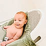 baby, infant, smile, bath, bathroom, green_cloth, white_bath_seat, happy, skin, cute, child, person, sitting, wrapped, young, indoors, clean, relaxed, comfort, portrait