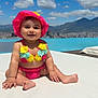 baby, child, bikini, pink_hat, flower_bikini, swimming_pool, outdoor, sunny, blue_sky, clouds, mountains, cityscape, happy, smiling, sitting, summer, vacation, water, skin, cute