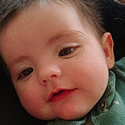 Liam joined the competition — help win amazing prizes! baby, child, face, infant, cute, smiling, clothing, green_outfit, blanket, soft_texture, portrait, young_child, closeup, indoors, relaxed, happy, skin, head, eyes, person