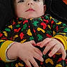 Liam is registered to the contest to win money with this photo: baby, child, infant, onesie, colorful_clothing, hands, face, portrait, lying_down, cozy, fabric, patterned_clothing, young_child, cute, indoor, soft_lighting, casual, relaxed, expression, person