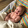 Finley is registered to the contest to win money with this photo: baby, blanket, smiling, colorful, striped, knit, cozy, infant, happy, child, soft, couch, indoor, portrait, cute, skin, young, hands, face, expression
