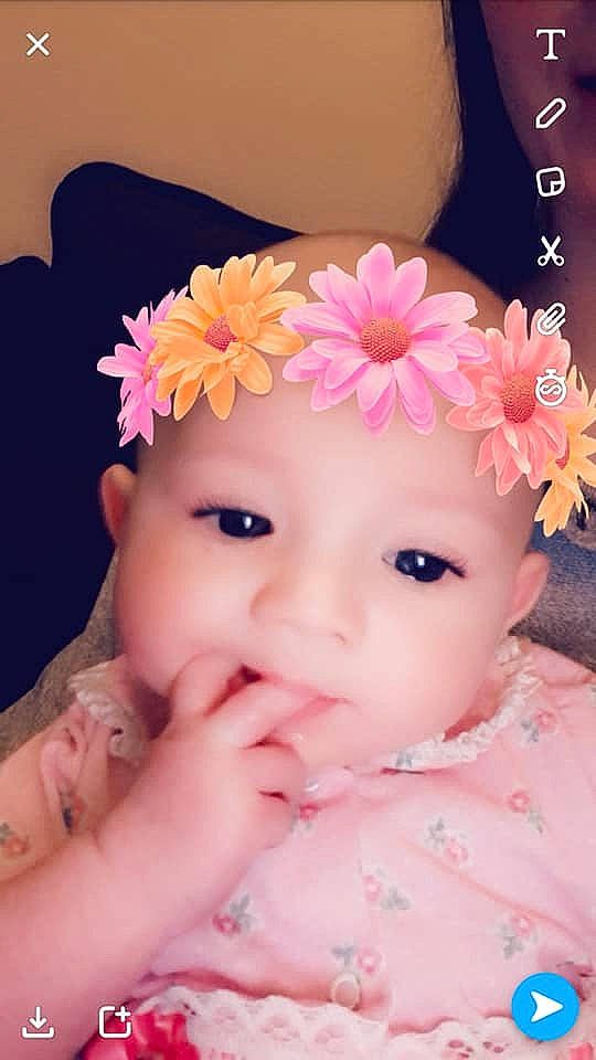 Jocelynn is registered to the contest to win money with this photo: beauty, cheek, child, close_up, eye, eyebrow, face, flower, forehead, girl, hair_accessory, head, human_hair_color, infant, nose, person, petal, pink, skin, smile