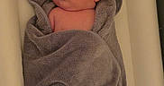 Julian joined the competition — help win amazing prizes! adorable, baby, bed, blanket, child, cute, ears, expression, face, gray, head, indoors, infant, lying, newborn, person, skin, soft, towel, wrapped