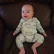 Julian joined the competition — help win amazing prizes! animal_prints, baby, child, clothing, comfortable, cute, happy, home, indoors, infant, leather_couch, one_person, pajamas, person, portrait, relaxing, sitting, small_child, smiling, young_child