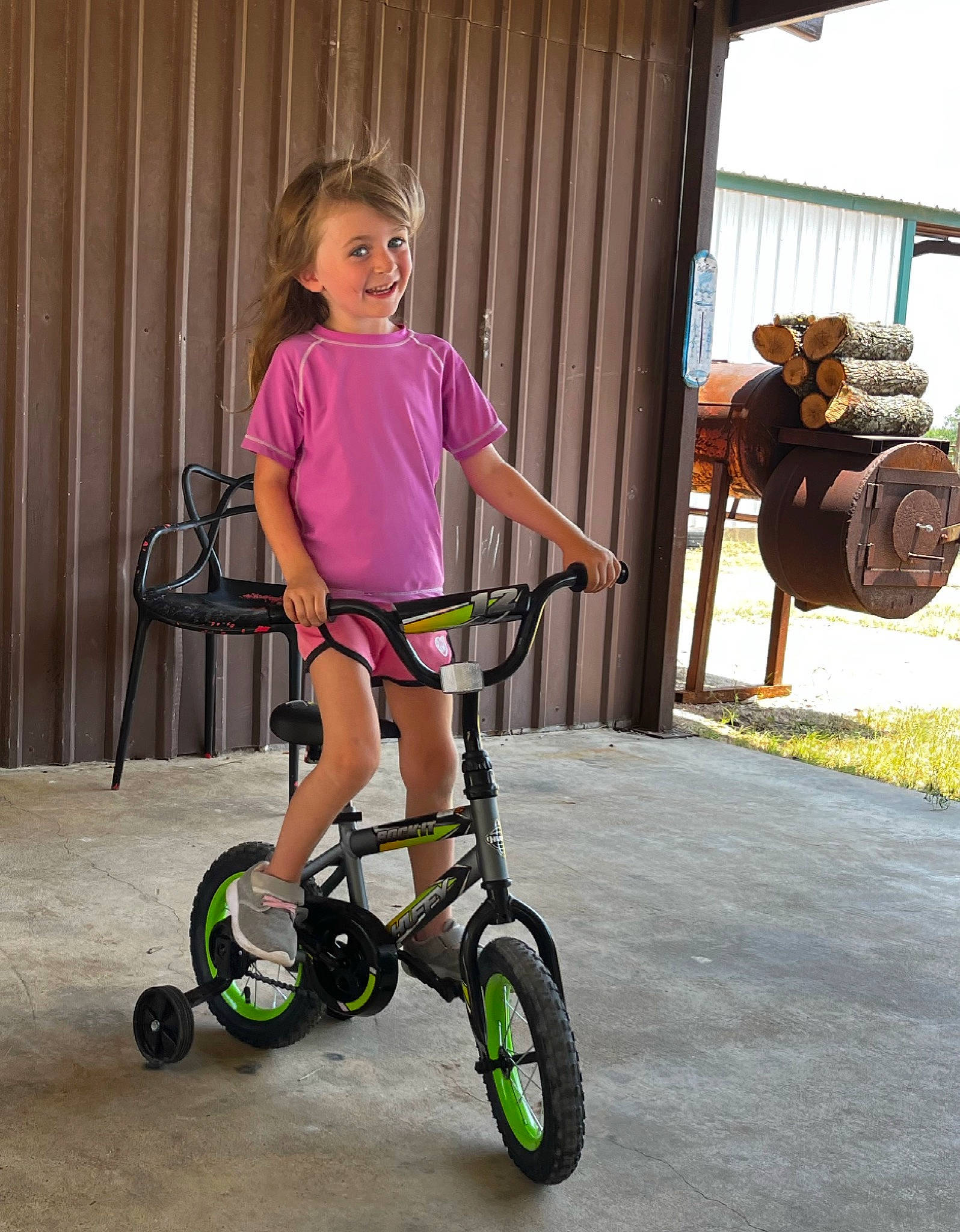 Charli is registered to the contest to win money with this photo: automotive_tire, bicycle, bicycle_accessory, bicycle_fork, bicycle_frame, bicycle_handlebar, bicycle_part, bicycle_tire, bicycle_wheel, bicycles_equipment_and_supplies, dress, face, joy, person, pink, rim, rolling, spoke, tire, toddler
