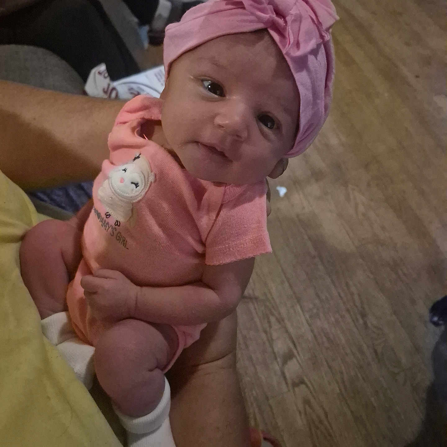 Helen Mae joined the competition — help win amazing prizes! arm, baby, baby_girl, casual, child, closeup, cute, floor, hand, holding, human, indoor, infant, newborn, person, pink_clothing, pink_headband, portrait, socks, wood_floor
