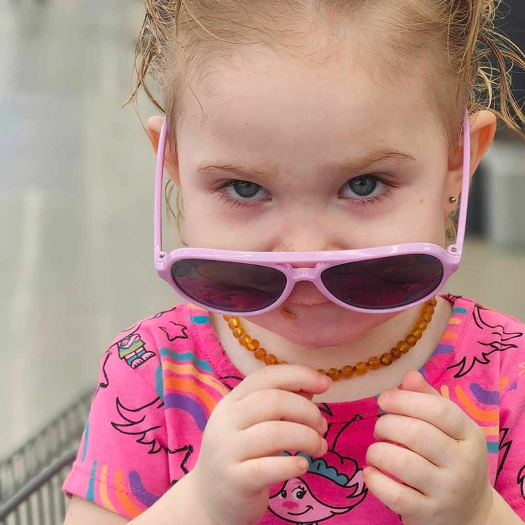 Talena joined the competition — help win amazing prizes! accessories, baby, biting, blonde, bodypart, clothing, eating, face, finger, food, hair, hand, head, jewelry, necklace, person, photography, portrait, sleeve, sunglasses