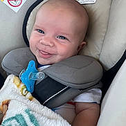 Brayden joined the competition — help win amazing prizes! arm, baby, blanket, car_seat, child, closeup, clothing, comfort, cushion, cute, face, happy, head, indoor, infant, neck_pillow, pacifier, seatbelt, skin, smile