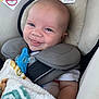 arm, baby, blanket, car_seat, child, closeup, clothing, comfort, cushion, cute, face, happy, head, indoor, infant, neck_pillow, pacifier, seatbelt, skin, smile