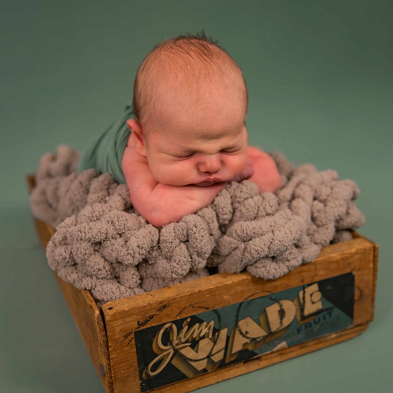 James is registered to the contest to win money with this photo: baby, blanket, bodypart, box, crate, crib, face, finger, furniture, hand, head, infantbed, newborn, person, photography, portrait, sleeping, towel