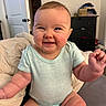 arms, baby, bed, bedroom, candid, child, clothing, face, furniture, gummy_smile, hands, happy, home, indoors, infant, onesie, photography, portrait, sitting, smiling