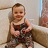 baby, child, smiling, sitting, armchair, patterned_clothing, indoors, happy, cute, infant, face, portrait, furniture, feet, hand, wall, curtain, cozy, room, bright