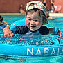 toddler, child, pool, water, inflatable_ring, swimming, hat, cap, summer, outdoor, happy, smiling, fun, sunny, play, water_toys, person, blue, vacation, recreation