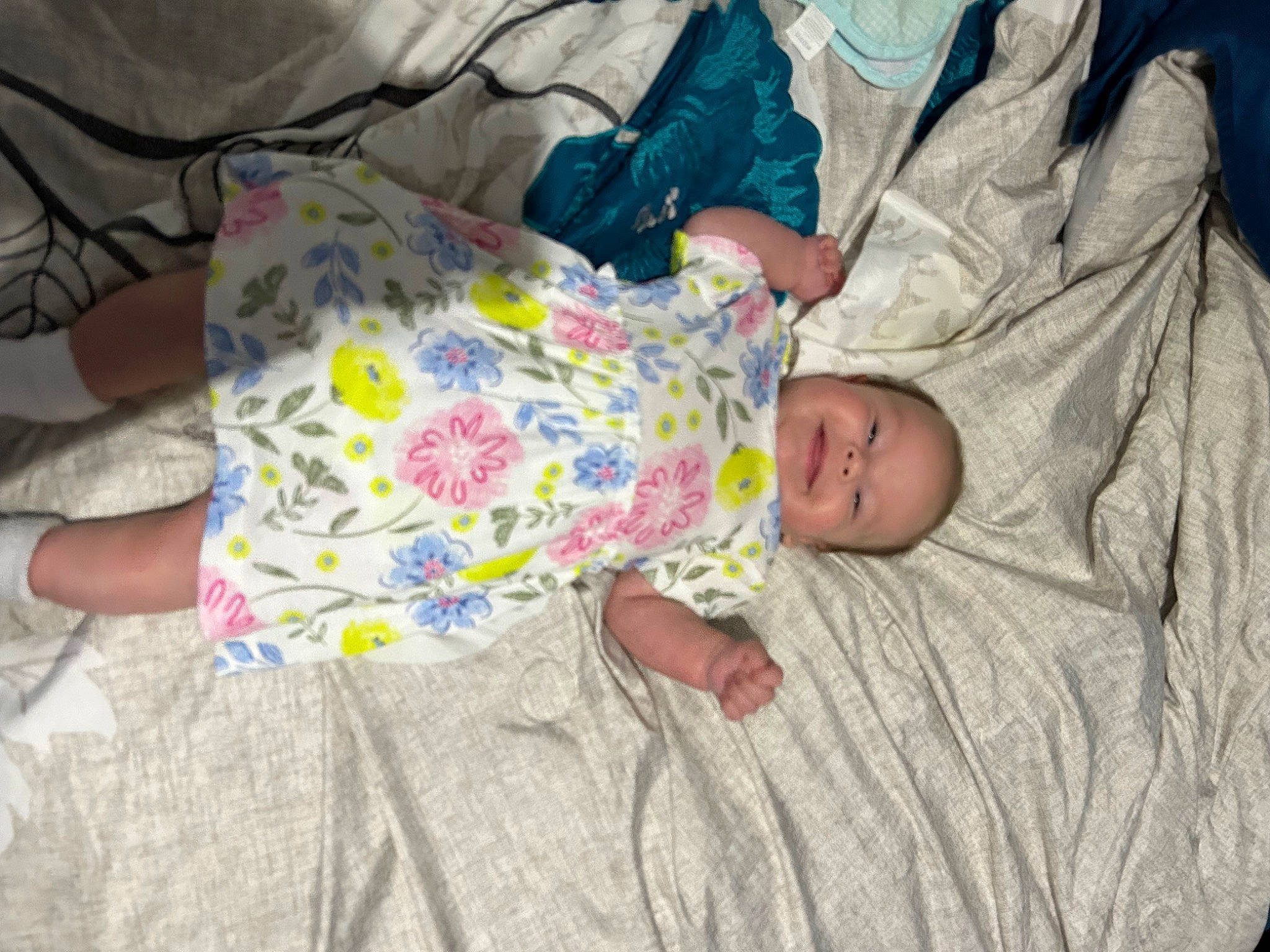 Skyler is registered to the contest to win money with this photo: baby, baby_toddler_clothing, bedtime, child, comfort, flooring, foot, human_leg, joy, linens, nap, pattern, person, room, sitting, skin, sleep, smile, toddler, wood