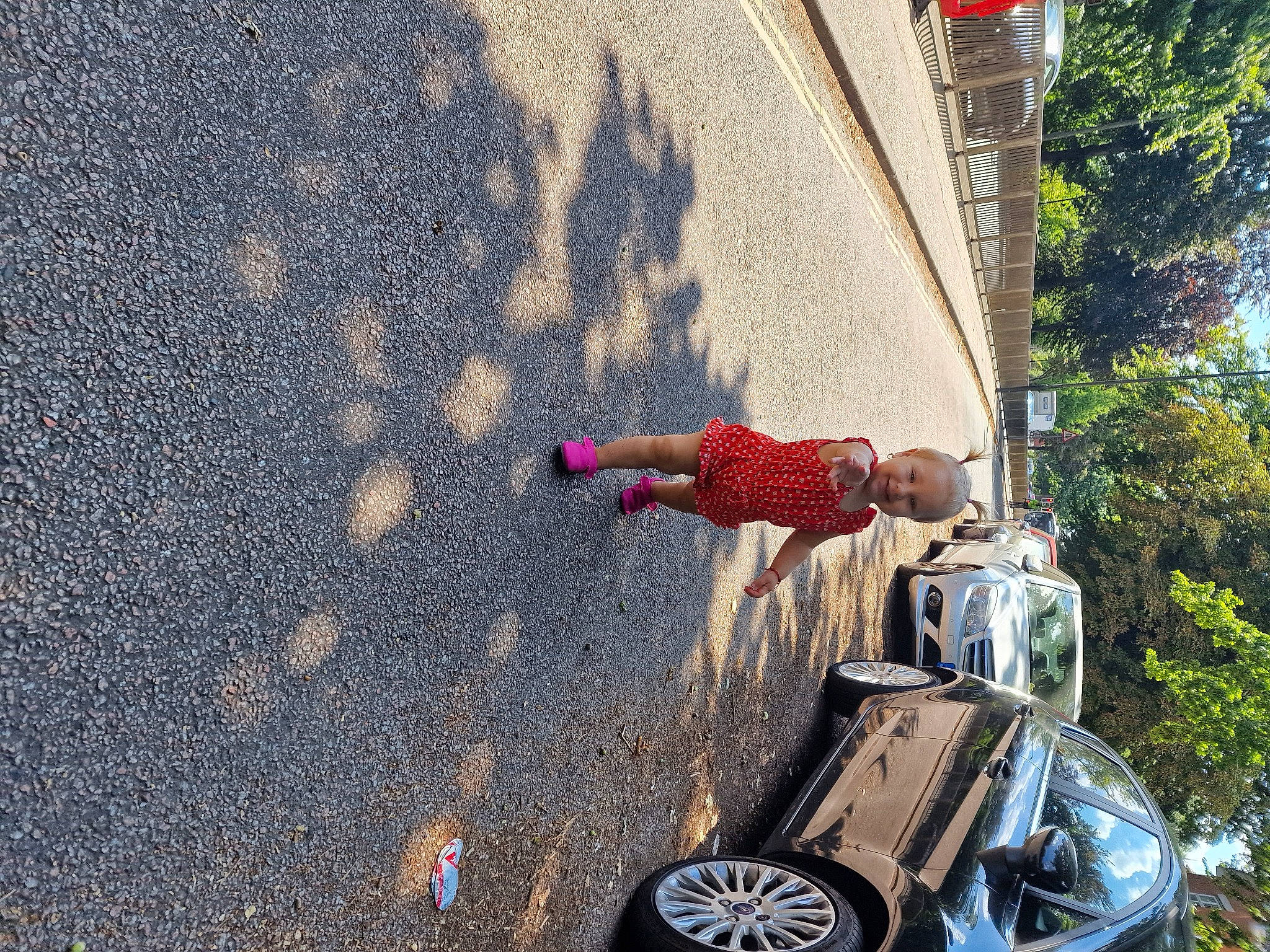 Evelin joined the competition — help win amazing prizes! asphalt, automotive_exterior, automotive_lighting, automotive_tire, bumper, car, dress, drum, joy, leisure, motor_vehicle, person, plant, road, road_surface, sidewalk, sky, tire, toddler, tree