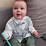 baby, child, toddler, couch, sofa, clothing, vest, bow_tie, green_pants, socks, brush, indoor, cute, smiling, happy, person, home, seated, face, expression