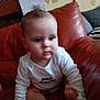 Arthur a rejoint le concours — aidez-le/la à gagner de superbes lots ! baby, child, cushion, cute, expression, face, foot, hand, home_interior, indoor, infant, leather_couch, person, petit_amour, portrait, red_couch, sitting, wallpaper, white_shirt, young