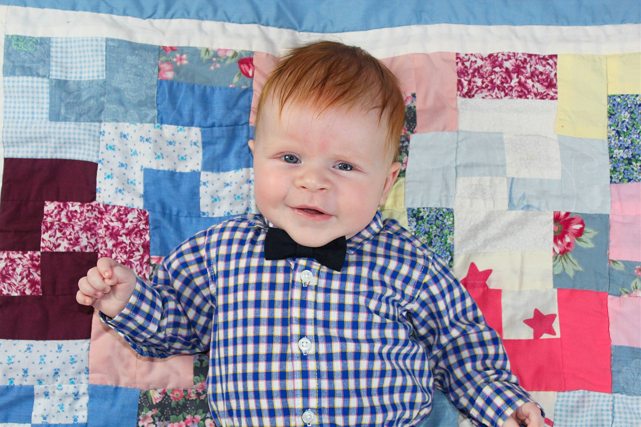 Cole is registered to the contest to win money with this photo: baby, baby_toddler_clothing, child, creative_arts, happy, head, linens, pattern, person, photograph, plaid, product, rectangle, red, room, sleeve, smile, t_shirt, tartan, textile